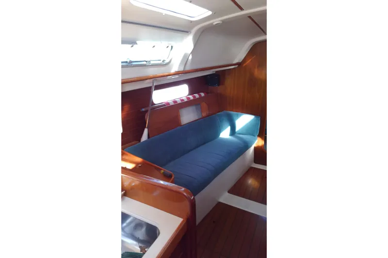 Slide: The Image of Interior of 1996 Beneteau Oceanis 321 sailboat with blue cushioned seating. - 16