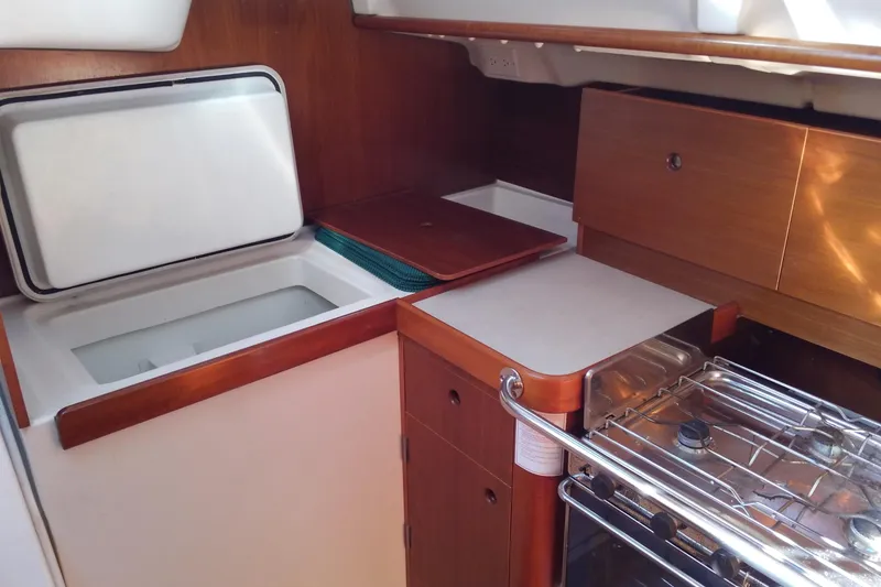 Slide: The Image of Interior view of 1996 Beneteau Oceanis 321 yacht kitchen with stove and storage. - 19