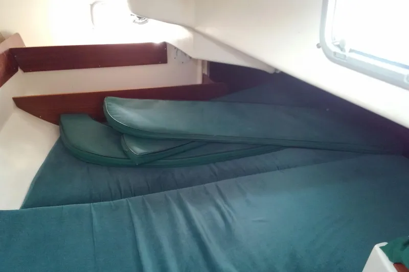 Slide: The Image of Interior cabin of 1996 Beneteau Oceanis 321 sailboat with green cushions. - 21