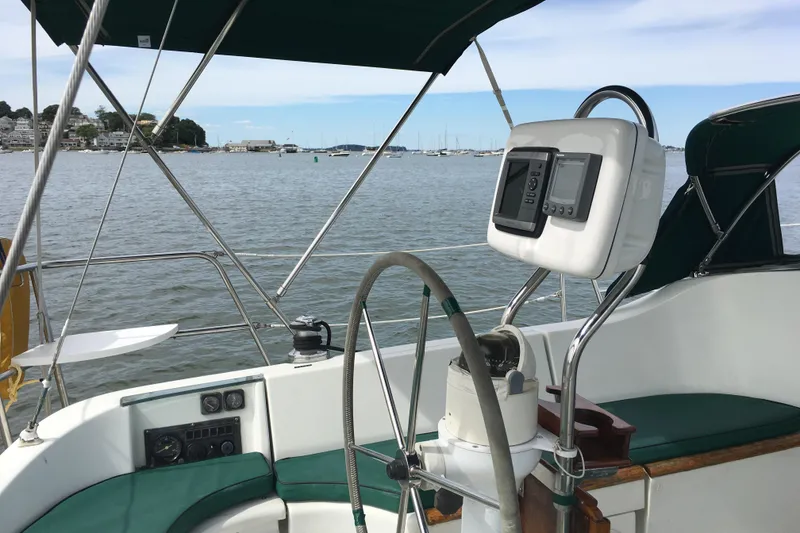 Slide: The Image of Cockpit of 1996 Beneteau Oceanis 321 sailboat with steering wheel and navigation equipment. - 4