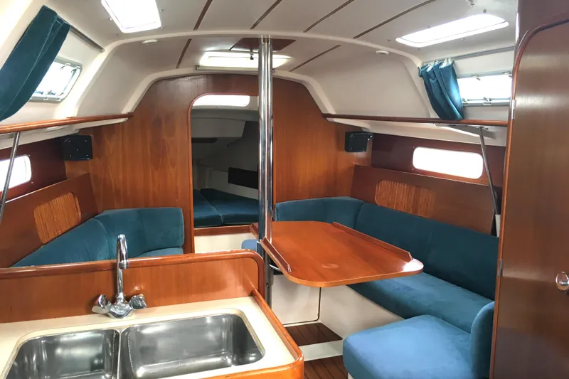 Slide: The Image of Interior of 1996 Beneteau Oceanis 321 sailboat with wood finish and blue upholstery. - 5