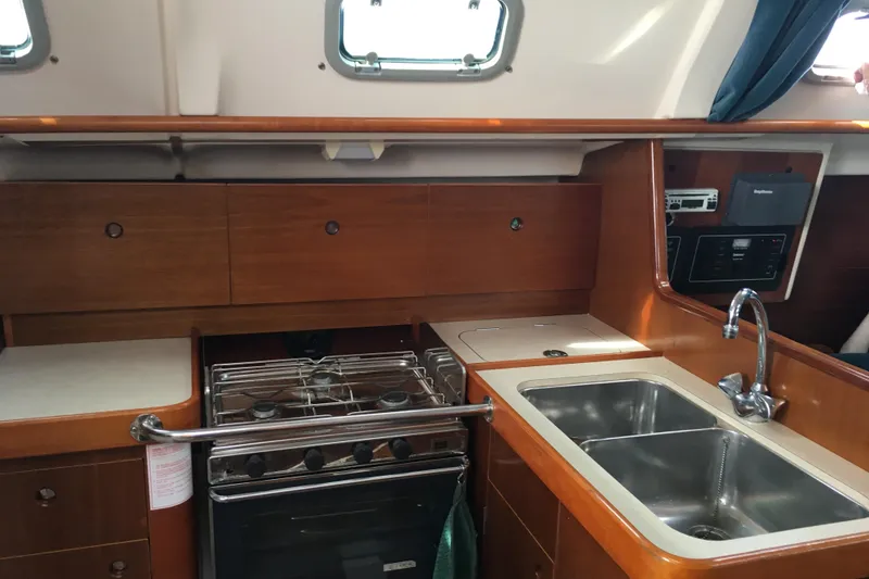 Slide: The Image of Interior view of 1996 Beneteau Oceanis 321 yacht kitchen with stove and sink. - 6