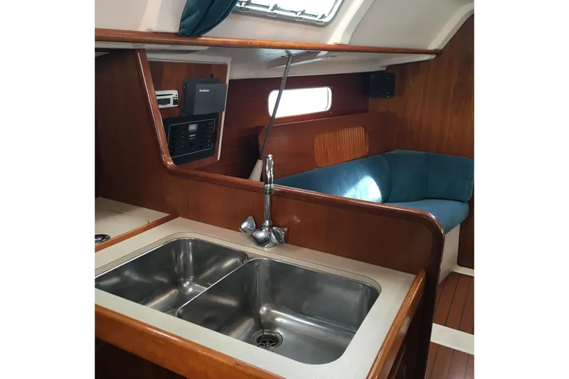 Slide: The Image of Interior of 1996 Beneteau Oceanis 321 yacht with sink and seating area. - 7