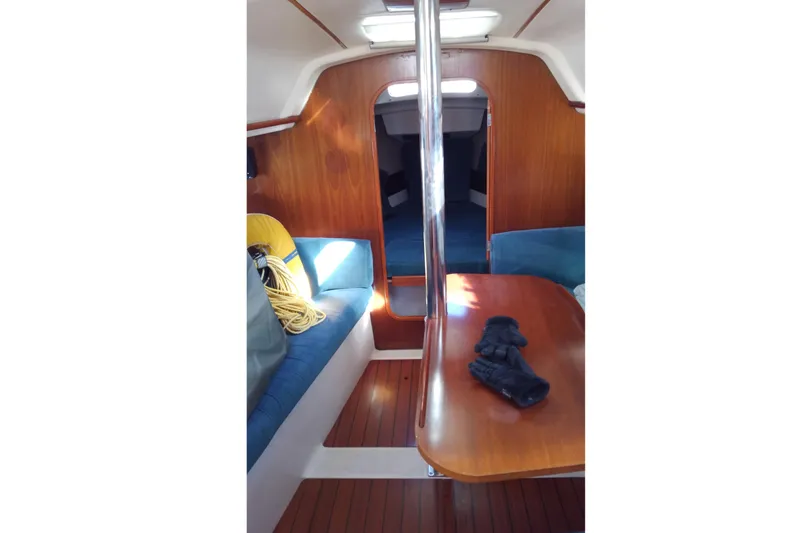 Slide: The Image of Interior of 1995 Beneteau Oceanis 321 sailboat with wooden finishes and seating area. - 8