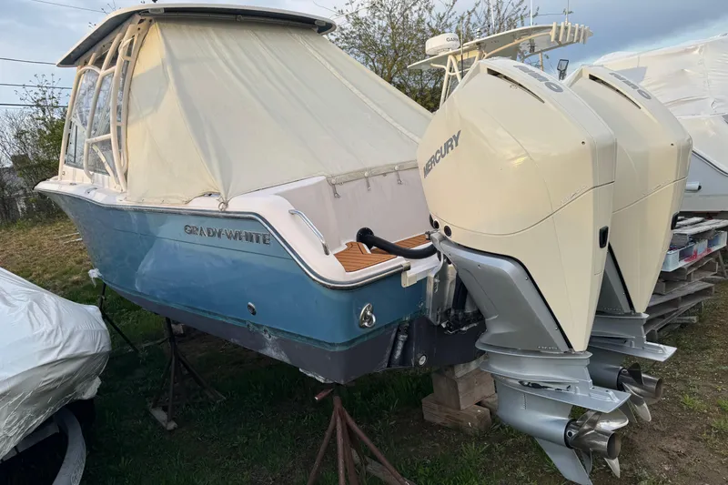 Slide: The Image of 2010 Grady-White Tournament 275 boat with dual Mercury outboard engines, covered and elevated. - 5