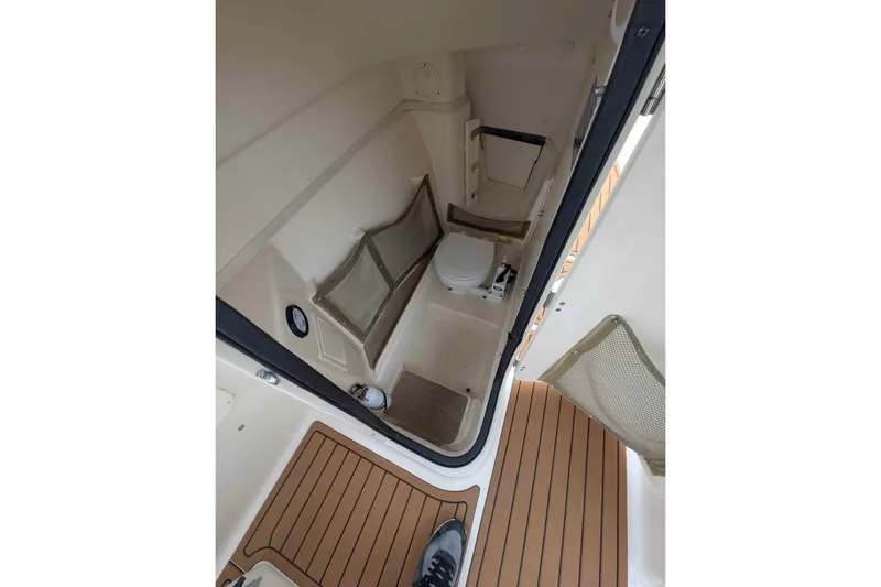 Slide: The Image of Interior view of 2010 Grady-White Tournament 275 boat's compact bathroom area. - 8