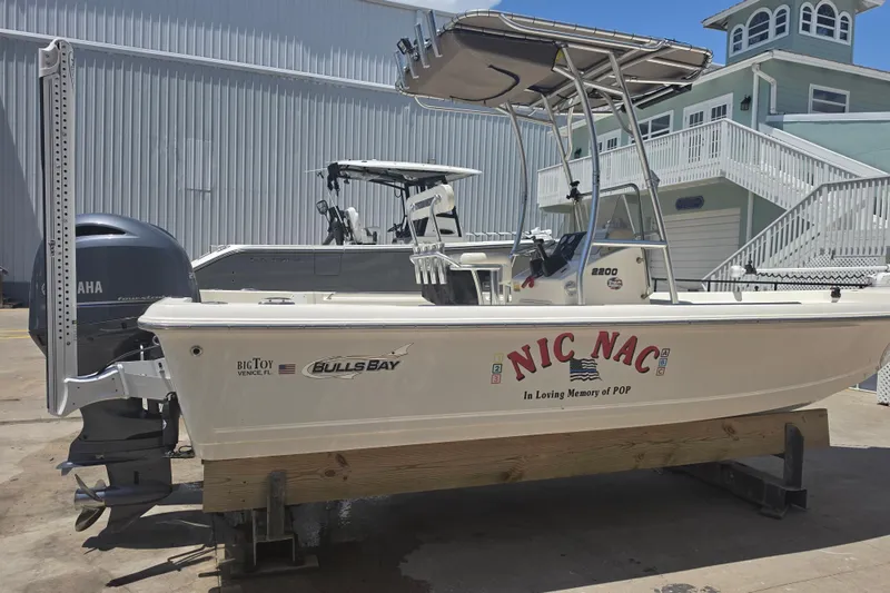 Slide: The Image of 2021 Bulls Bay 2200 boat named "Nic Nac" on display with Yamaha engine. - 10