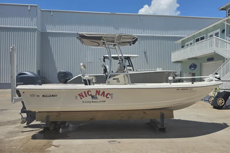 Slide: The Image of 2021 Bulls Bay 2200 boat named "Nic Nac" on display at a marina. - 11