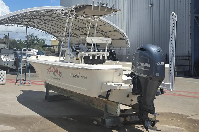 Slide: The Image of 2021 Bulls Bay 2200 boat with Yamaha engine in a marina setting. - 2