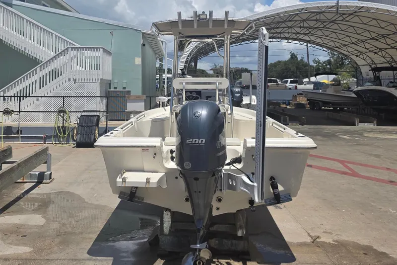 Slide: The Image of Bulls Bay 2200 boat, 2021 model, docked at a marina under a clear blue sky. - 4