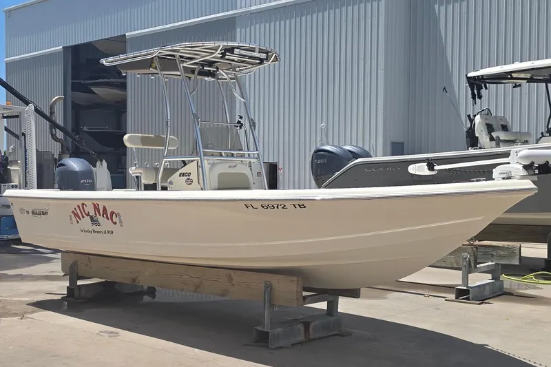 Slide: The Image of 2021 Bulls Bay 2200 boat on dock, forklift nearby, sunny day at marina. - 9