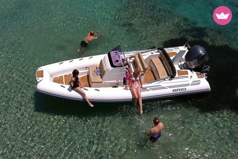 Slide: The Image of 2026 Brig Eagle 6.7 boat in clear water with people enjoying a sunny day. - 13