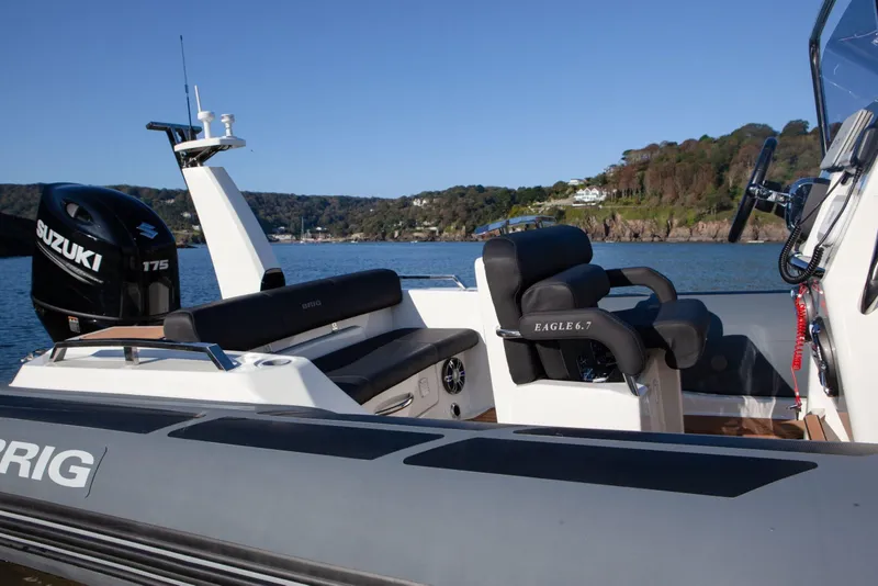 Slide: The Image of 2026 Brig Eagle 6.7 boat with Suzuki engine, on calm water, scenic background. - 15