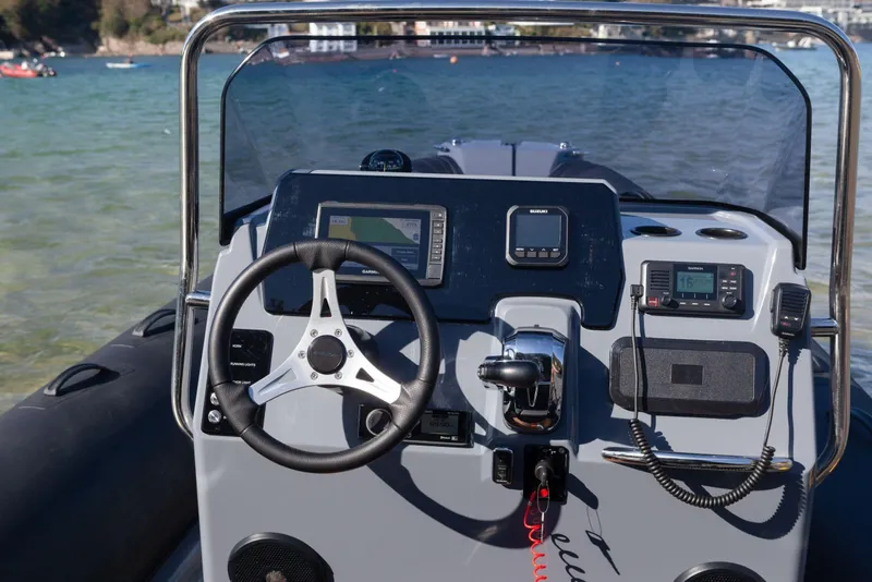 Slide: The Image of 2026 Brig Eagle 6.7 boat dashboard with steering wheel and navigation controls. - 19