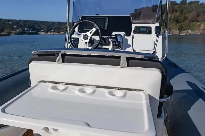 Slide: The Image of Manufacturer Provided Image: 2026 Brig Eagle 6.7 boat cockpit with steering wheel and control panel on water. - 8