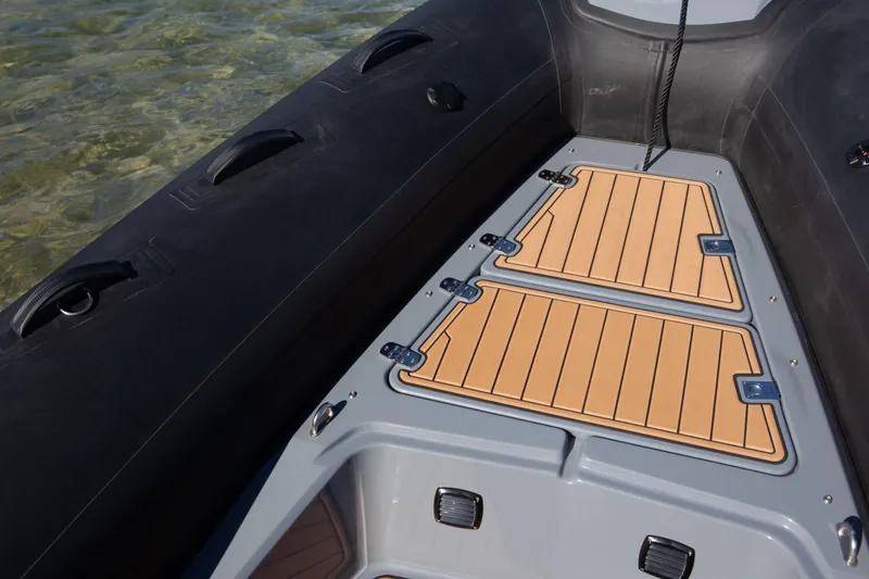 Slide: The Image of 2026 Brig Eagle 6.7 boat deck with sleek design and wood-patterned flooring. - 9