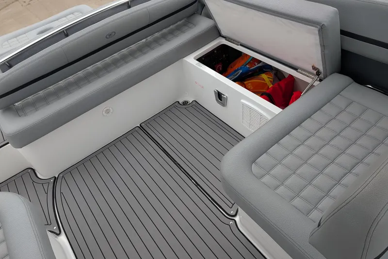 Slide: The Image of 2021 Cobalt R7 boat interior with open storage compartment and gray seating. - 12