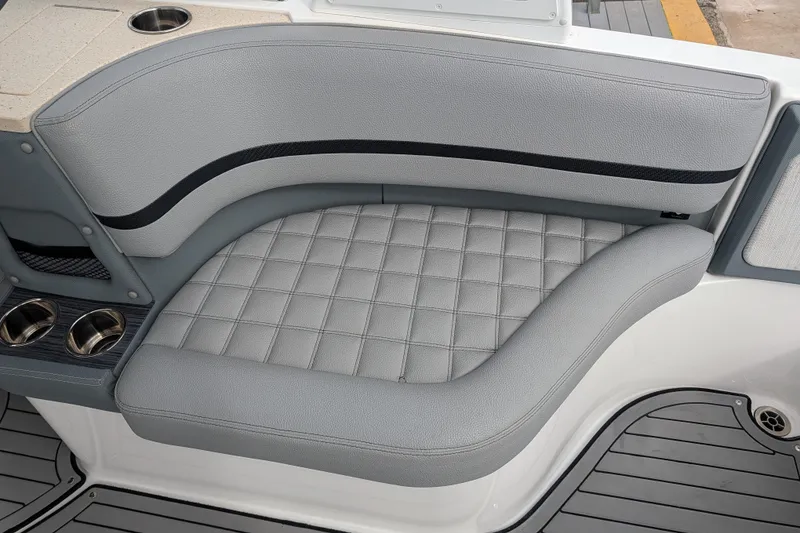 Slide: The Image of 2021 Cobalt R7 boat interior with gray cushioned seating and cup holders. - 14