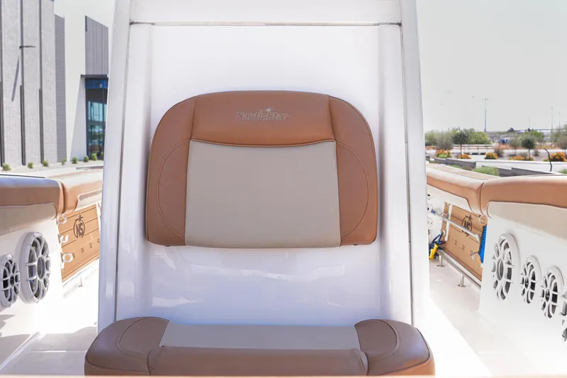Slide: The Image of 2024 NauticStar 292 Legacy boat seat with tan and beige upholstery. - 20