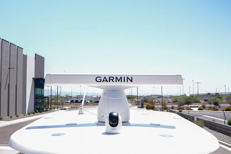 Slide: The Image of Garmin radar on 2024 NauticStar 292 Legacy boat, parked near modern building. - 25