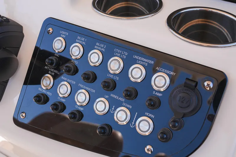 Slide: The Image of Control panel of 2024 NauticStar 292 Legacy boat with various switches and buttons. - 26