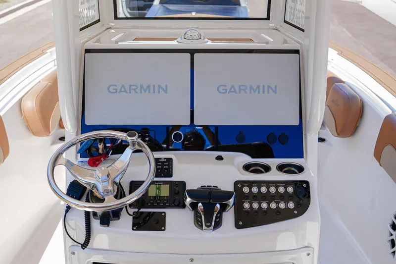 Slide: The Image of 2024 NauticStar 292 Legacy boat dashboard with Garmin displays and controls. - 28