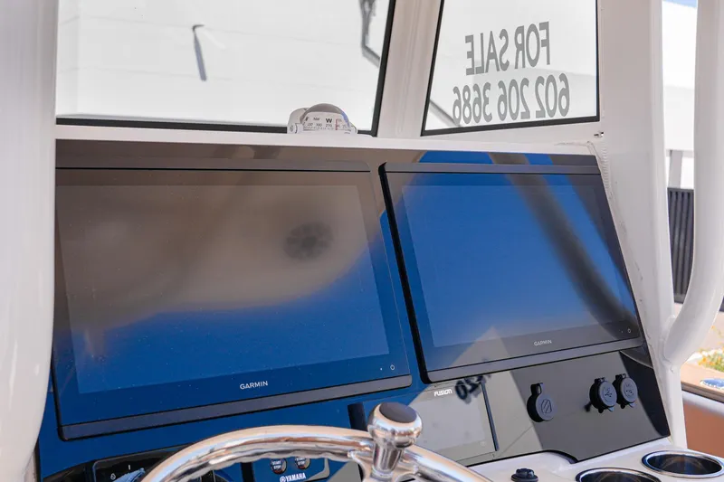 Slide: The Image of 2024 NauticStar 292 Legacy boat dashboard with dual Garmin displays. - 30