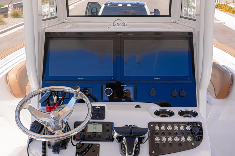 Slide: The Image of 2024 NauticStar 292 Legacy boat dashboard with dual Garmin displays and modern controls. - 31