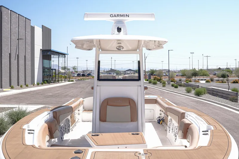 Slide: The Image of 2024 NauticStar 292 Legacy boat with Garmin equipment, docked near modern building. - 4