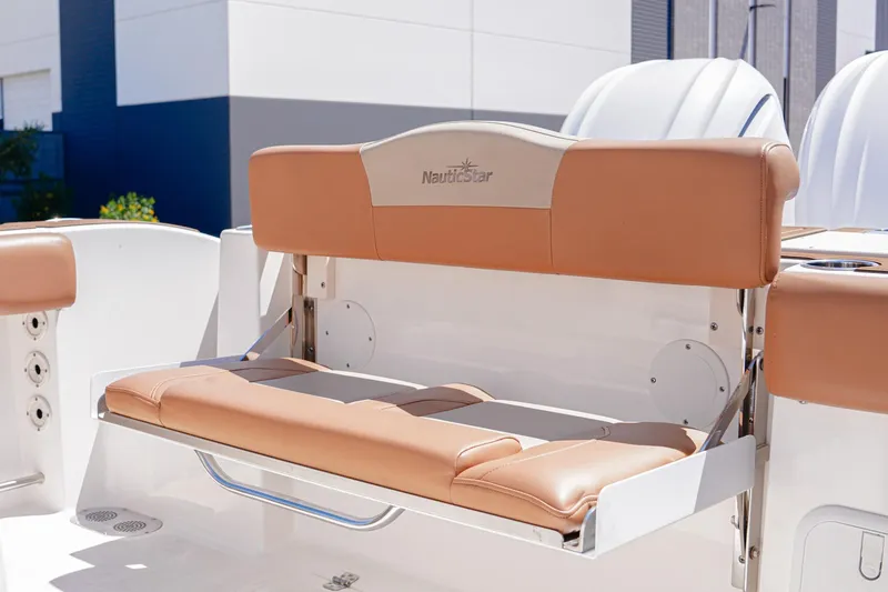 Slide: The Image of 2024 NauticStar 292 Legacy boat seat with tan upholstery and foldable design. - 7