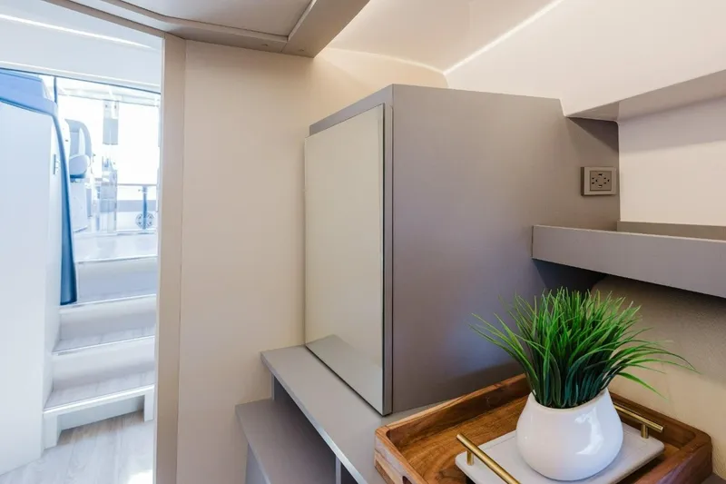 Slide: The Image of Modern interior of Hanover 415 yacht, featuring sleek design and decorative plant, 2027 model. - 12