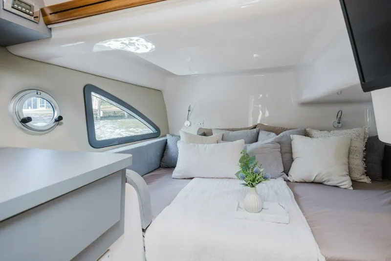 Slide: The Image of Cozy interior of 2027 Hanover 415 boat with plush bedding and decorative pillows. - 6