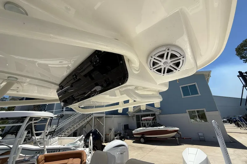 Slide: The Image of 2026 Key West 230 Bay Reef boat with speaker system, docked outdoors under clear sky. - 11