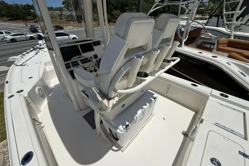 Slide: The Image of 2026 Key West 230 Bay Reef boat interior with dual helm seats and control panel. - 12