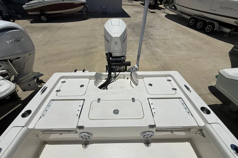 Slide: The Image of 2026 Key West 230 Bay Reef boat with Mercury outboard motor, docked in a marina. - 14