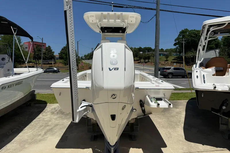 Slide: The Image of 2026 Key West 230 Bay Reef boat with V8 engine displayed outdoors. - 3