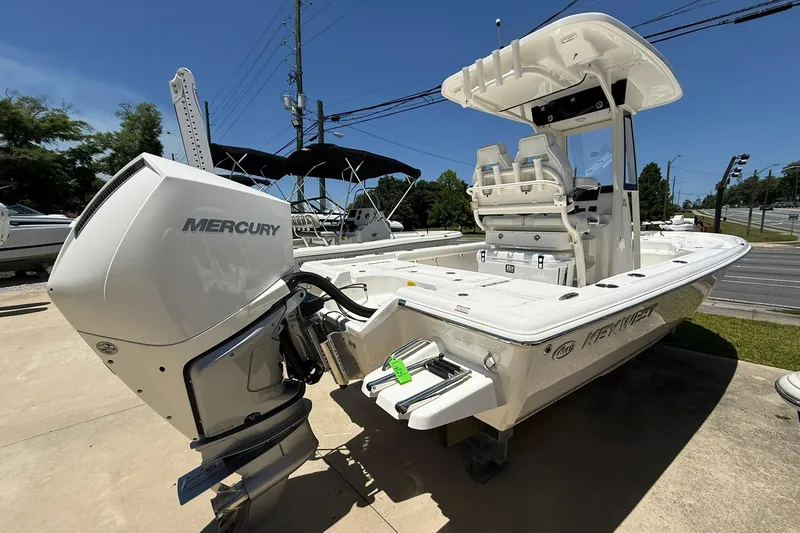 Slide: The Image of 2026 Key West 230 Bay Reef boat with Mercury engine, displayed outdoors. - 4