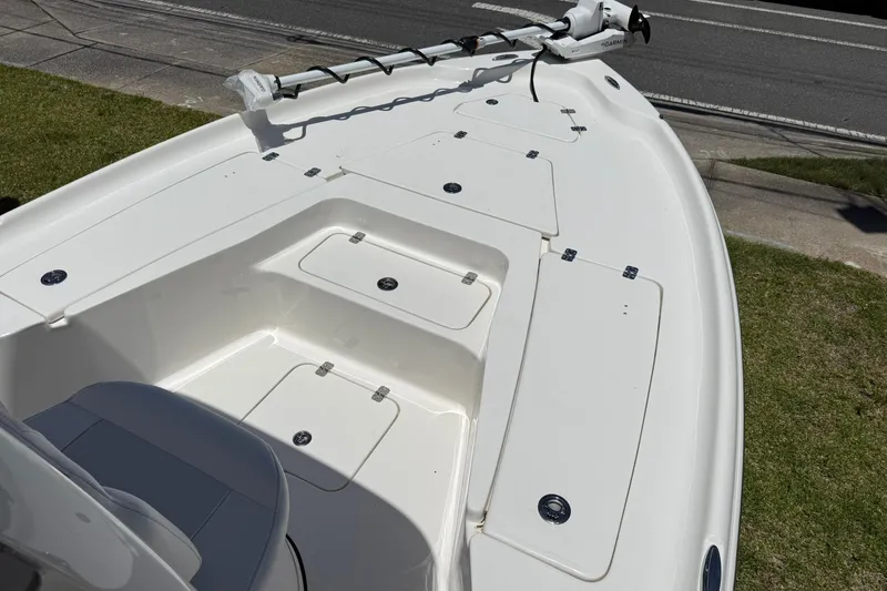 Slide: The Image of 2026 Key West 230 Bay Reef boat deck with storage compartments and trolling motor. - 5
