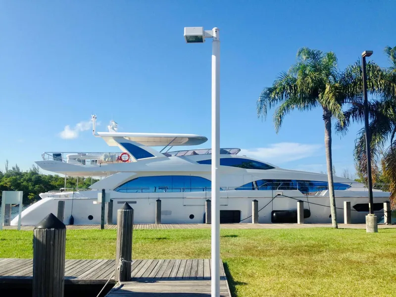 Slide: The Image of 2014 Azimut 100 Grande yacht docked near palm trees. - 1