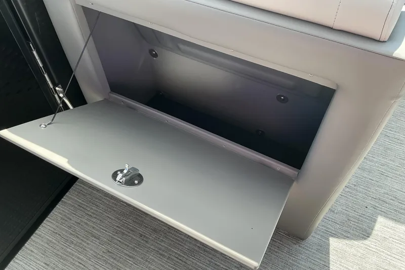 Slide: The Image of Open storage compartment in 2025 Qwest E-Class RLS 16 boat interior. - 10