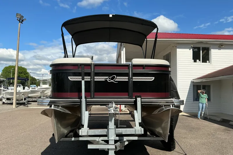 Slide: The Image of 2025 Qwest E-Class RLS 16 pontoon boat on trailer, outdoor dealership setting. - 4