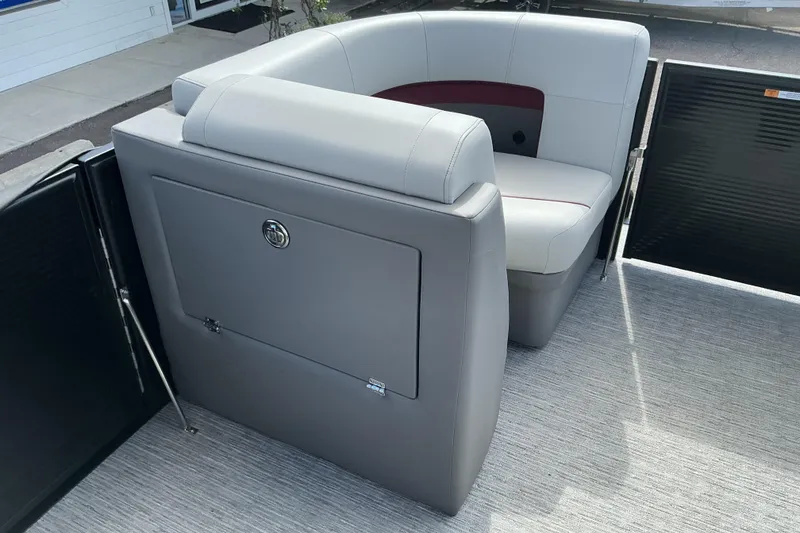 Slide: The Image of 2025 Qwest E-Class RLS 16 boat interior with gray seating and storage compartment. - 5
