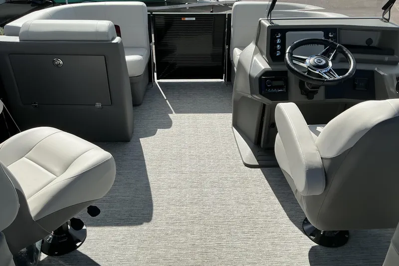 Slide: The Image of 2025 Qwest E-Class RLS 16 boat interior with modern seating and steering console. - 6