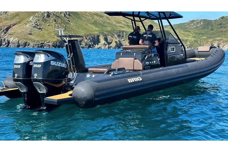 Slide: The Image of Manufacturer Provided Image: 2026 Brig Eagle 10 boat with Suzuki engines on clear blue water. - 2