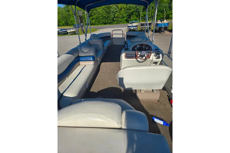 Slide: The Image of 2005 Lowe Jamaica 250SD pontoon boat interior with seating and steering wheel. - 3