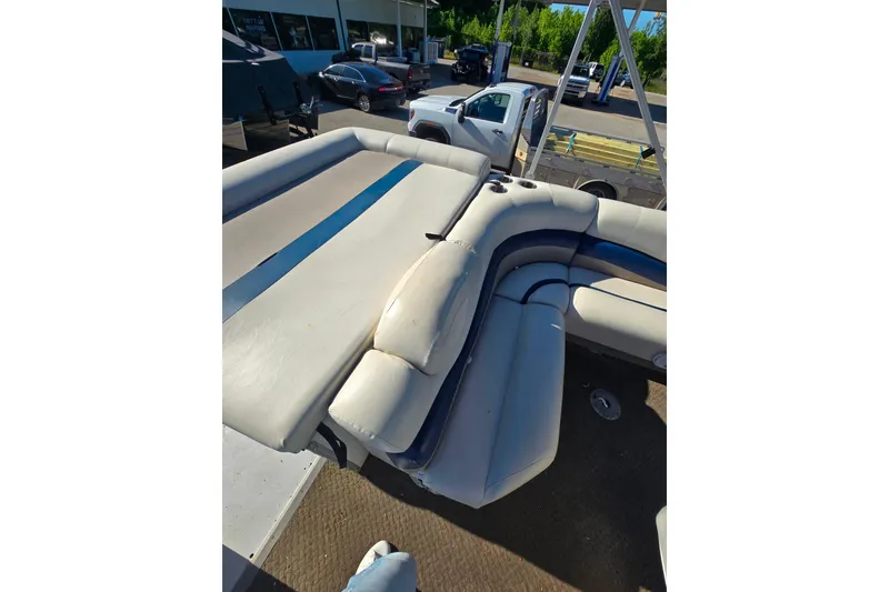 Slide: The Image of 2005 Lowe Jamaica 250SD boat interior with beige and blue seating. - 6
