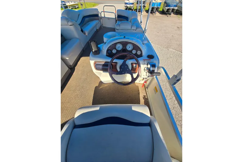 Slide: The Image of 2005 Lowe Jamaica 250SD boat interior with steering wheel and seating area. - 8