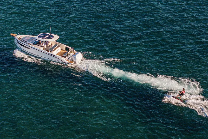 Slide: The Image of Manufacturer Provided Image: Aerial view of Navan S30 boat towing a wakeboarder on open water, 2026 model. - 14
