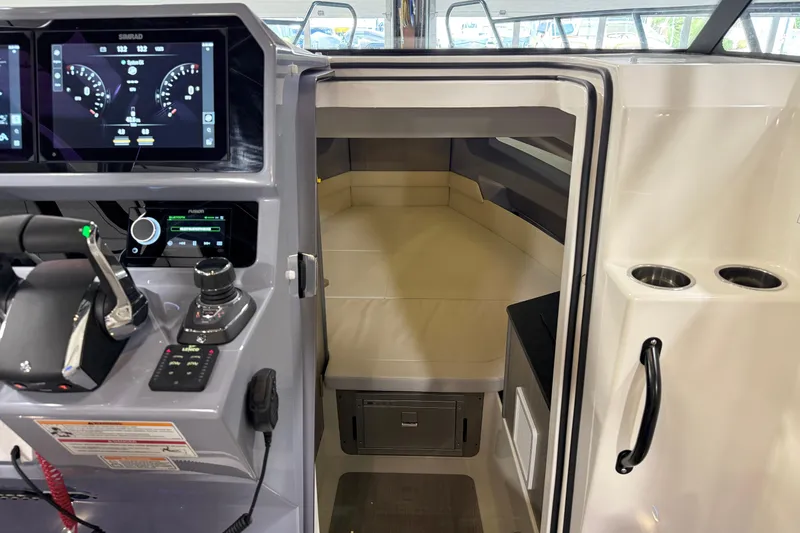 Slide: The Image of Interior view of 2026 Navan S30 boat cockpit with modern controls and cabin entrance. - 5