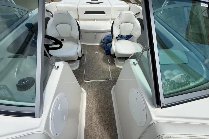 Slide: The Image of Interior of a 2012 Chaparral 18 H2O Sport boat with seating and steering wheel. - 14